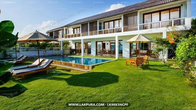 Villa Tanderra - modern villa with pool, lawn, and sun loungers overlooking garden