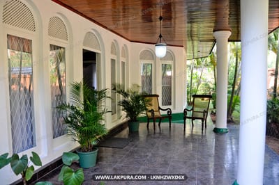 Swetha Villa - covered veranda with arched doorways, potted plants and seating area