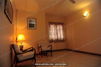 Secure Villa - warm-lit room with two chairs and small table by window
