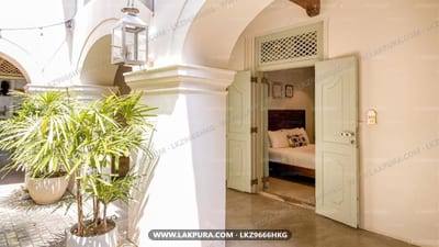 The Bartizan - arched corridor with potted plant and bedroom doorway