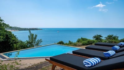 Red Cliffs - infinity pool overlooking calm blue ocean and distant coastline