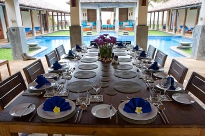 Auraliya - formal dining table set for dinner with pool courtyard view