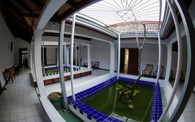 Riverside - indoor courtyard with blue-tiled pool and artificial grass field