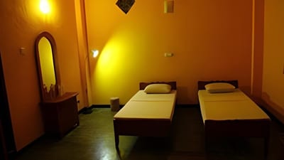 Reef Edge - two single beds in warm-lit room with mirror